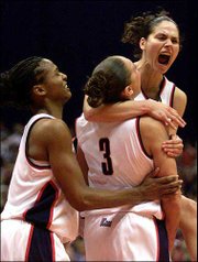 Connecticut's Asjha Jones, left, Diana Taurasi (3) and Sue Bird
celebrate the Huskies' 82-70 victory over Oklahoma in the NCAA
women's title game Sunday night in San Antonio.
