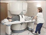 Magnetic resonance imaging technician Shawna Gannaway, right,
removes a patient from the open MRI at Lawrence Memorial Hospital
South, 3510 Clinton Parkway Place. The open construction of this
type of MRI offers greater patient comfort than a traditional MRI,
LMH officials say.
