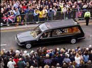 The hearse carrying the coffin of Queen Elizabeth, the Queen
Mother, strewn with flowers thrown by members of the public,
arrives at Windsor Castle following her funeral service at
Westminster Abbey. The queen mother was buried Tuesday next to her
husband, George VI, in St. George's Chapel at the castle.