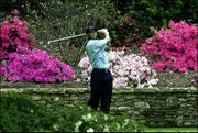 Tiger Woods watches his tee shot on the 13th hole. Woods shot a
6-under 66 on Saturday in Augusta, Ga., to share the lead with
Retief Goosen heading into today's final round of The Masters.