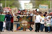 nearly 200 people participated in a protest march from South Park
to the Baker Wetlands. The protesters Sunday were voicing
opposition to the South Lawrence Trafficway.