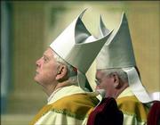 Cardinal Bernard Law of Boston, left, and Cardinal William Keeler
of Baltimore reflect during a Mass at the Cathedral Basilica of
Saints Peter and Paul in Philadelphia. Law's admission in January
that he allowed a pedophile priest to continue to serve sparked a
new level of public anger in the U.S. Catholic church. The
resulting scandal has brought news of 176 priests across the
country resigning or being removed from the clergy for molesting or
being suspected of molesting minors and sparked a meeting last week
between U.S. cardinals and Pope John Paul II in Rome.