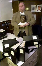 Kansas City police Sgt. Dave Bernard holds a bust of Precious Doe.
A year after her headless body was discovered in a wooded area of
the city, authorities are still stumped by the killing of the
unidentified girl. Bernard displayed the bust Friday at police
headquarters in Kansas City, Mo.