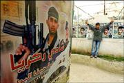 A poster in the Jenin Refugee Camp in the West Bank glorifies
Palestinian suicide bomber Shadi Zakaria. Zakaria killed 15 people
and himself in a March 31 suicide attack in Haifa. Suicide bombings
have grown so much in appeal and popularity among Palestinians that
a cult has evolved around them.