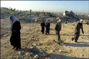 Palestinian women walk past the rubble of destroyed houses at the
Jenin refugee camp in the West Bank. A U.N. fact-finding team that
was scheduled to arrive Sunday to investigate Israel's military
operation in the camp has been delayed because of disagreements
between Israel and the United Nations about the scope of the
commission's work.
