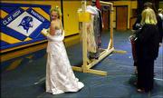 Samantha Cummings, 15, left, a freshman at Clay County High School,
checks the length of a donated prom dress as her teachers Dana
Remias and Christine Walker look on recently in Clay, W.Va.
Students at a $20,000-a-year girls school in New York City donated
about 450 gowns to girls in the West Virginia area.