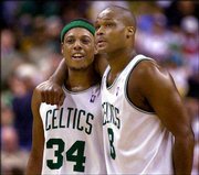 Boston forward Paul Pierce and teammate Antoine Walker share a
moment in the third quarter. Pierce had 46 points as the Celtics
hammered Philadelphia, 120-87, on Friday in Boston.