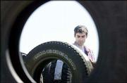 Lawrence resident John Lupo looks for the perfect tread among a sea
of tires at the A & R Sales booth at the 39th annual Lawrence
auto swap meet. Used automotive parts and accessories drew
thousands of gearheads from near and far Saturday to the Douglas
County Fairgrounds.