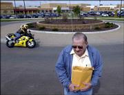 School bus driver Doug Bowen, who is upset with the city's
roundabouts, has taken his complaints to multiple city commission
meetings and is on the agenda for Monday night's Traffic Safety
Commission meeting. On Thursday Bowen was at the site of a
roundabout in front of Sunflower School on Inverness Street.