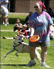 Traci Fullerton, Lawrence, competes in the flying-disc competition
with her dog, Beth. Twenty dogs and their owners competed Sunday in
the competition in conjunction with Art in the Park at South Park.
