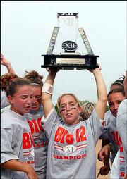 Texas's Tiffany Anders holds up the Big 12 trophy after Texas
defeated Nebraska in the title game of the Big 12 Conference
softball tournament. UT won the title Sunday in Oklahoma City.