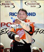 Tony Stewart sprays the crowd as he celebrates his win in the
rain-delayed NASCAR Pontiac Excitement 400. Stewart won the race
Sunday in Richmond, Va.