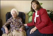 Rhonda Parks, the new executive director at Lawrence Presbyterian
Manor, visits with 93-year-old resident Florence Sandberg. Lawrence
Presbyterian Manor is following the trend to provide a more
homelike atmosphere at its facilities.