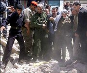 Palestinian leader Yasser Arafat, center, is helped by aides to
walk through the rubble as he inspects the damage caused by the
latest Israeli military operation in the Old City of the West Bank
town of Nablus. The town was one of several toured by Arafat
Monday.