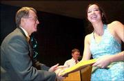 Kate Myrick receives her copy of a President's Award for
Educational Excellence from Free State High School Principal Joe
Snyder. About 150 students from the FSHS senior class were
recognized at an honors ceremony Monday night.