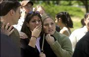 Jennifer Kluge of Chicago, who will graduate today from Kansas
University, gets a hug from her sister Michelle. Jennifer, a fine
arts major, lived in the apartments to the north of the building
that was destroyed. She said she was concerned about her art and
belongings, which may have been damaged.