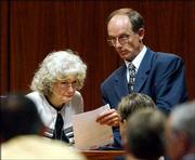 Mary Frances Cunningham, left, a witness for the defense, looks at
a document shown by defense attorney Mickey Johnson in the murder
trial of Bobby Frank Cherry in Birmingham, Ala. Cherry is on trial
for the 1963 bombing of the Sixteenth Street Baptist Church, which
killed four girls. Cunningham, a former FBI informant, testified
Saturday that she never told agents she saw Cherry plant the bomb
that blew up a church.