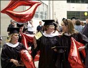 Speech-Language Pathology graduate students, from left, Ashley
Little of Fairway, Michelle Calton of Lee's Summit, Mo., and
Lindsay Randle of Arkansas City make their way to the Campanile for
the beginning of commencement.