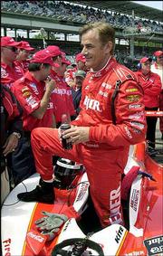 Two-time Indy 500 champion Arie Luyendyk smiles as he climbs out of
his car. He qualified with an average speed of 228.848 mph on the
final day of qualifying Sunday at the Indianapolis Motor Speedway.
