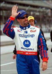 Michael Andretti waves to the fans after he made the field on the
final day of qualifications Sunday at the Indianapolis Motor
Speedway.
