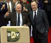 Stephen Ambrose, historian and founder of the National D-Day
Museum, thanks former President George Bush during ceremonies at
the museum in this Dec. 7, 2001, file photo, in New Orleans.
Ambrose, who wrote the 1994 best seller "D-Day," is working on a
new book depicting his own transformation from a left-wing
demonstrator to a super patriot.