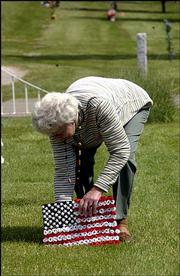 Connie Webb-Smith, Lake Lotawan, Mo., drove to Lawrence, her
hometown, to place a flag on her brother's grave in preparation for
Memorial Day. Area veterans' groups have planned ceremonies
throughout the weekend.
