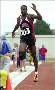 Lawrence High's Richard Mumford skies in the Class 6A long jump. He
placed sixth Friday at Cessna Stadium.