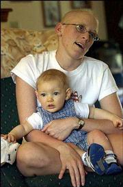 Melissa Wingert discusses the surgeries and chemotherapy treatments
she has endured. She holds her 7-month-old nephew Joshua Kibbee.