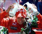 Indianapolis 500 champion Helio Castroneves pours two bottles of
milk onto his head. He won his second consecutive Indy 500 on
Sunday in Indianapolis.