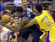 Sacramento's Chris Webber, left, protects the ball while being
guarded by Robert Horry of Los Angeles. The Lakers rallied to
defeated Sacramento, 100-99, Sunday at Los Angeles and tied the
Western Conference finals 2-2. Horry hit the game-winning basket.