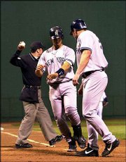 New York's Jason Giambi, right, celebrates his two-run homer with
teammate Jorge Posada. The Yankees hit six homers in their 14-5
victory Sunday at Boston.