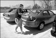 A KU Parking Services worker prepares to issue a ticket on campus.
Permit-related offenses are $20 each, and parking meter fines are
$5.