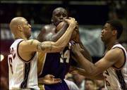 New Jersey's Kenyon Martin, left, and Jason Collins, right, try to
strip the ball from Shaquille O'Neal of Los Angeles. O'Neal was
named MVP of the NBA Finals for the third straight year Wednesday
at East Rutherford, N.J.