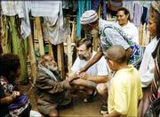 Teske visits with Natan, a man who helped maintain the mission
station where they lived in Papua New Guinea. The photo was taken
in 1997.