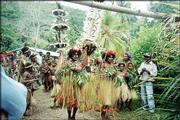 Men and women in traditional dancing dress lead a delegation into a
worship service in April in Papua New Guinea.
