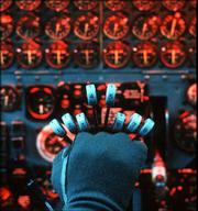 The gloved hand of a pilot holds the controls of the eight engines
required to lift the giant B-52 bomber off the runway. During the
Cold War B-52's and their crews were on 24-hour alert to deliver
nuclear weapons anywhere in the world. The first B-52 was built 50
years ago and many flying today are older than their pilots.