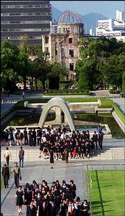 The structure in the background is called the A-Bomb Dome. It was
one of the few structures standing after the 1945 nuclear blast.
It's on the grounds of the Hiroshima Peace Memorial Museum, a site
that's visited often by Japanese school children.