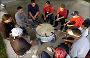 A small group of Upward Bound Summer Academy participants beat a
drum and sing American Indian songs at Haskell Indian Nations
University. About 55 teen-agers are participating in the academy.