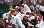 Texas players celebrate after winning the College World Series
championship. The Longhorns held off South Carolina, 12-6, on
Saturday in Omaha, Neb.