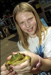 Louise Bouye, 10, Lawrence, shows the frog she entered in the
jumping-frog contest during the Lecompton Territorial Day festival.
Bouye attended the outdoor event Saturday with her grandmother,
Anna Marie Hickock, of Lecompton.