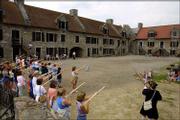 Rich Strum, director of interpretative education at Fort
Ticonderoga, conducts wooden gun drills with visitors on the parade
ground of the fort in Ticonderoga, N.Y. This summer and fall,
various state, federal, and privately operated historic sites are
commemorating the 225th anniversary of the turning point of the
Revolutionary War.
