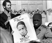 Ron Washington, chairman of the Black Students Union at Kansas
University, left, addresses a strike rally on campus in this file
photo from December 1970, as an unidentified youth displays a sign
in memory of Rick "Tiger" Dowdell. Dowdell was fatally shot while
fleeing police on July 16, 1970.