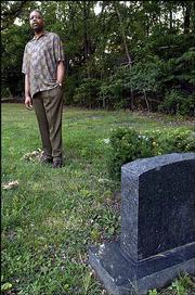Stephen Dowdell visits his brother Rick Dowdell's grave in Oak Hill
Cemetery. Rick Dowdell was fatally shot while fleeing police on
July 16, 1970, while racial tensions were coming to a boil in
Lawrence.