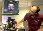 Carnegie Mellon University computer scientist Reid Simmons
manipulates the expressions on the face of GRACE, Graduate Robot
Attending Conference, a prototype robot in the lab at the school in
Pittsburgh. The group Simmons works with hopes to have GRACE
register itself at the registration desk, find its way to a
conference room to give a speech about itself and answer questions
from people at a robotics convention this weekend in Canada.