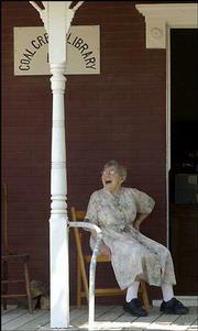 Martha Smith, 96, is the librarian at the Coal Creek Library in
Vinland. Wednesday Smith sat on the porch of the library, believed
to be the oldest continuously operating library in the state.