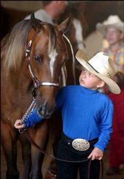 Kailyn Smith, 7, Lawrence, stands with her horse Dime, at the
Douglas County 4-H Fairgrounds. Kailyn was showing Dime Saturday in
the annual horse show, which kicked off the the week's fair
festivities.
