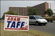 A political sign for Adam Taff, a Republican candidate for
Congress, is placed between the sidewalk and Iowa Street, just
north of 19th Street. City officials on Monday removed many
political signs placed illegally on city rights-of-way.