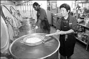 Kansas University dining services workers Richard Turner, left, and
Kuni Lieberman, prepare pasta for an evening meal during summer
school.