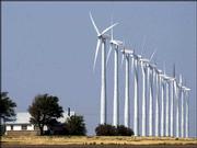 A farm house near Montezuma, about 25 miles southwest of Dodge
City, is dwarfed by a row of 13 wind turbines standing 230 feet
tall. These electricity-producing, wind-generated turbines are a
segment of the 170 machines that are located on 12,000 acres of
farmland alongside a stretch of U.S. Highway 56. Farmers are paid
about $2000 per year per tower.