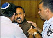 Marwan Barghouti, the West Bank chief of Yasser Arafat's Fatah
movement, shouts as he is pushed out of the courtroom on the
opening day of his court case at Tel Aviv's District Court.
Barghouti is charged by the Israeli authorities with murder,
attempted murder and involvment with terrorists organizations.
Israel said he was the key figure in organizing attacks by members
of a Fatah-affiliated militia.